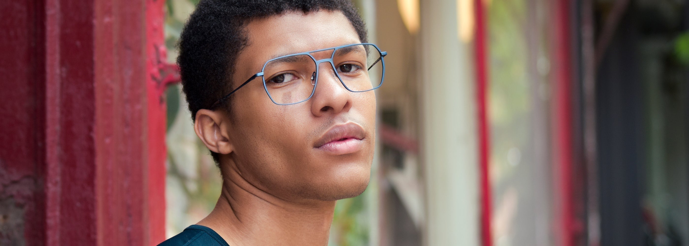 Stylish man wearing Vint & York’s oversized Matera eyeglasses, showcasing a bold and modern eyewear look for 2025.